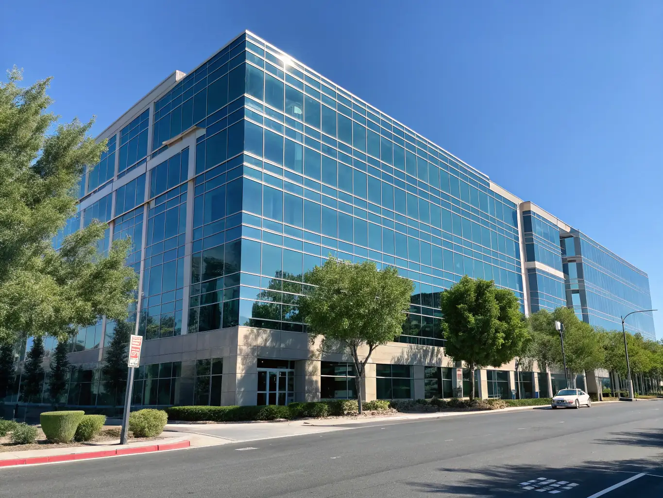 A commercial building with a spotless facade and a clean parking lot, demonstrating the impact of commercial power washing services.